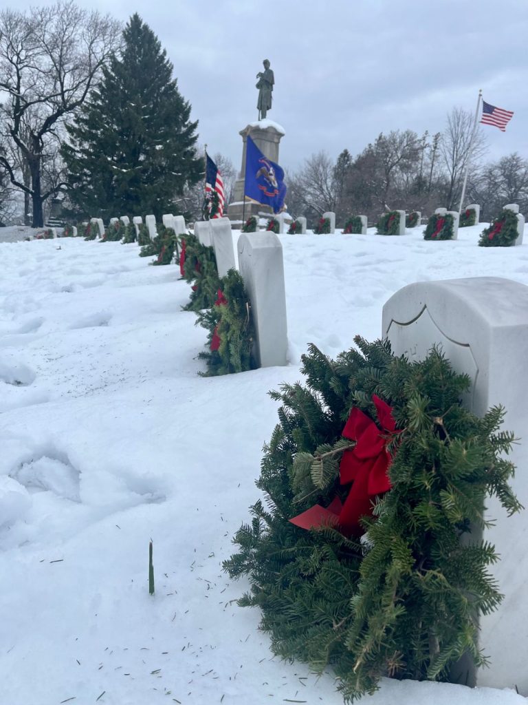 wreaths placed on graves at cemetery