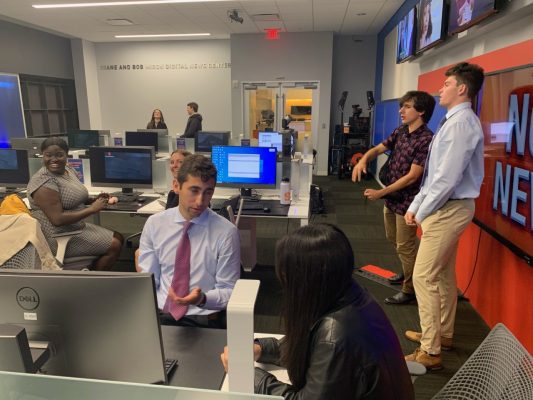 Students working in a busy newsroom