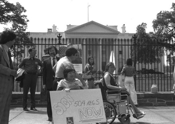 people standing and in wheelchairs outside of the White House