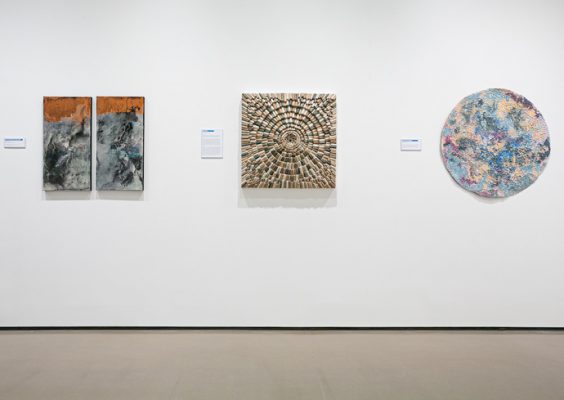 three artworks displayed on a gallery wall