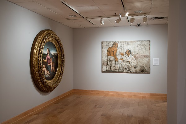 two large paintings displayed on a wall in a museum 