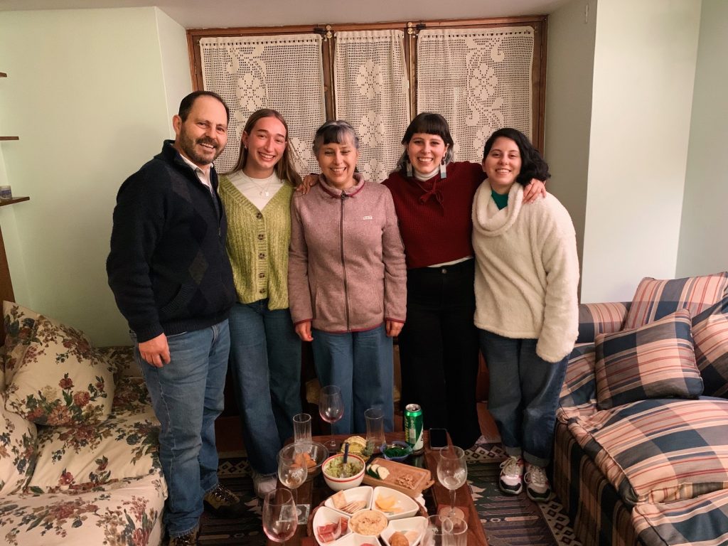 five people standing in a living room