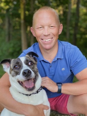 Rob Buyea ’99, G’00 with his dog in front of trees