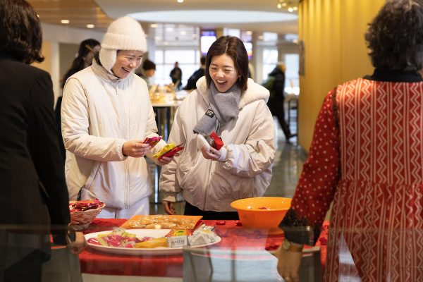 students picking up snacks at Newhouse School Lunar New Year Celebration