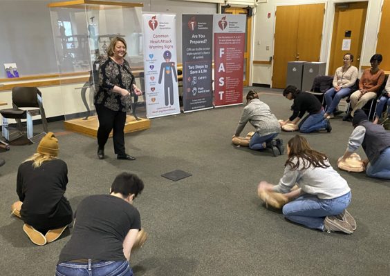faculty and staff participate in a CPR/AED training with an American Heart Association facilitator in the Hall of Languages