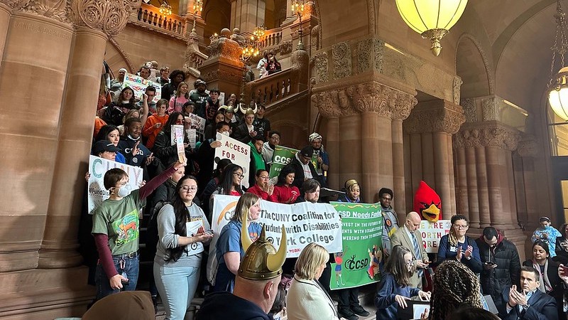 students from various colleges and universities across New York gather to advocate for increased state funding for disability services in higher education at the state capitol