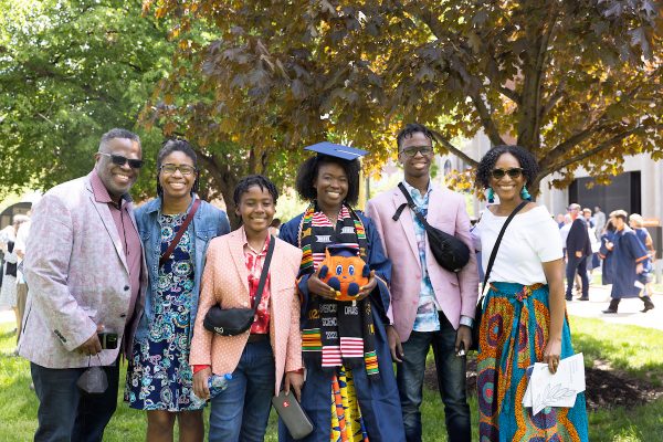 Family members gather around a Syracuse University graduate.