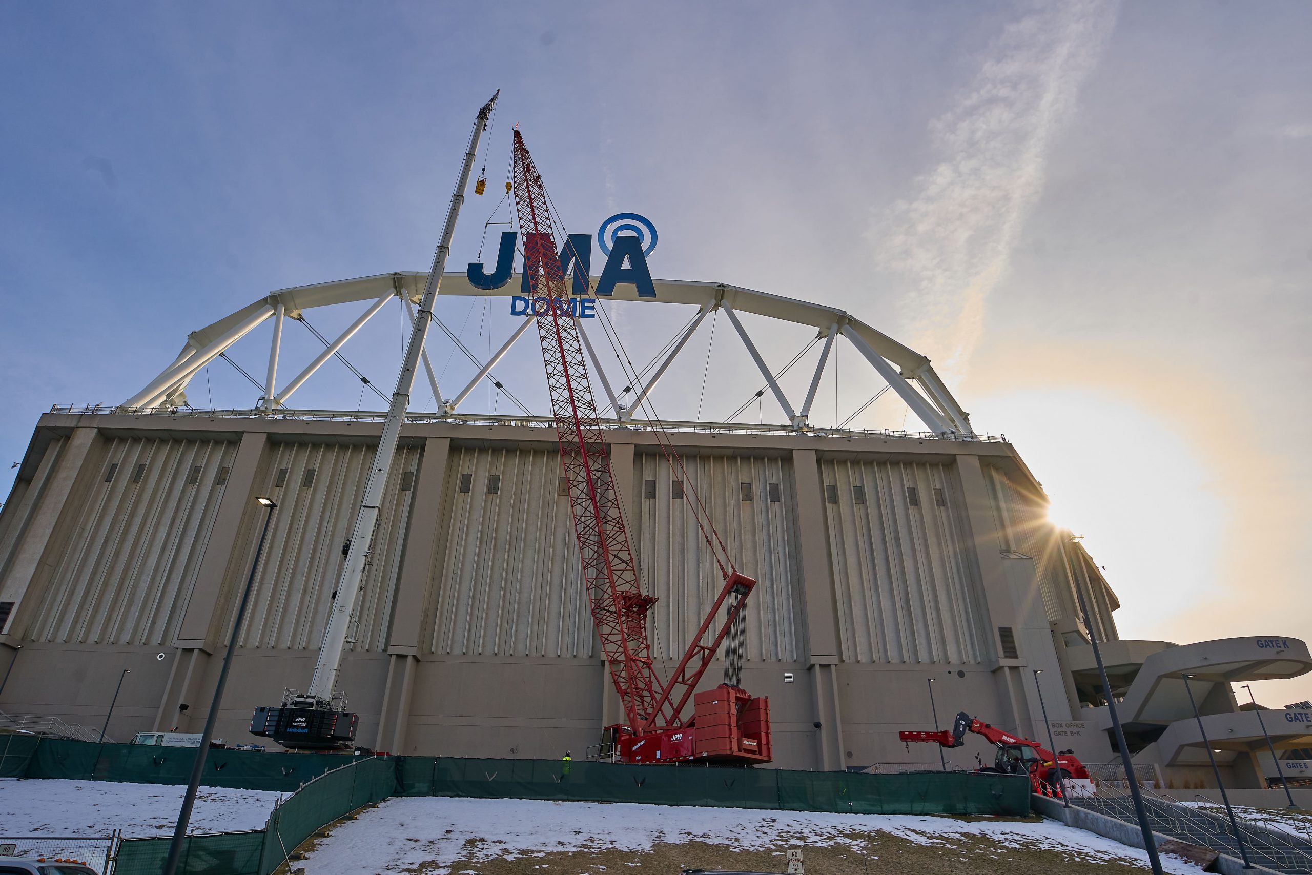 Crane installing JMA Dome sign to the crown truss on the Dome.