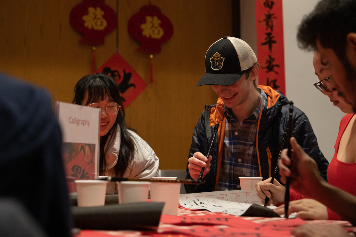 students practicing calligraphy at the Chinese New Year celebration
