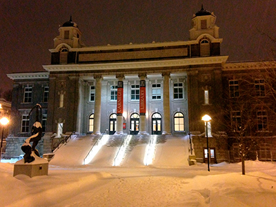 Exterior of Carnegie Library at night covered with fresh snow