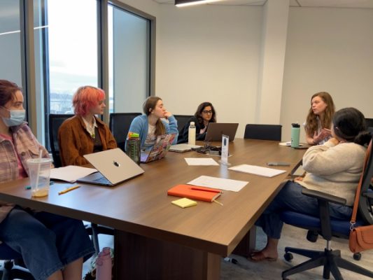 group of young women holding a discussion