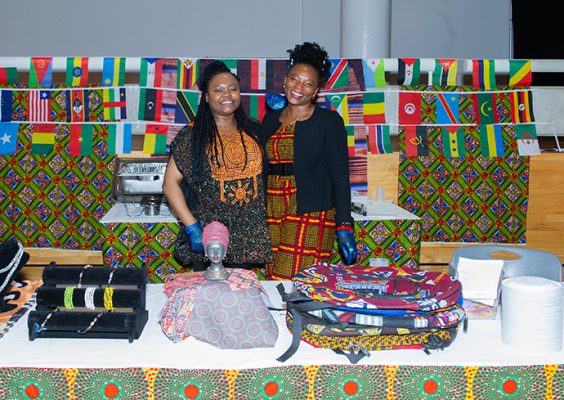 Two individuals standing at table during the international festival