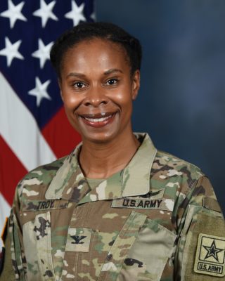Woman smiling while wearing her Army uniform.