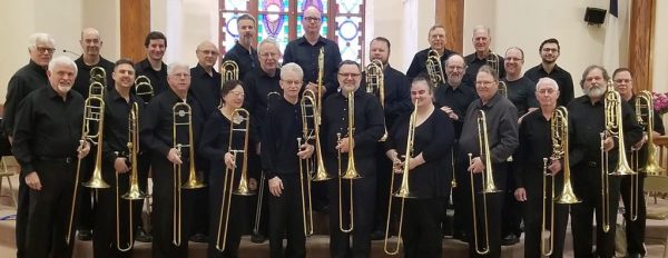 instrumental performers of Bones East pose together in a church