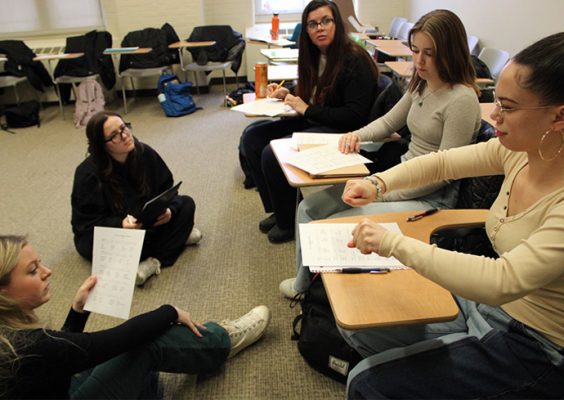 group of five students participating in an American Sign Language course