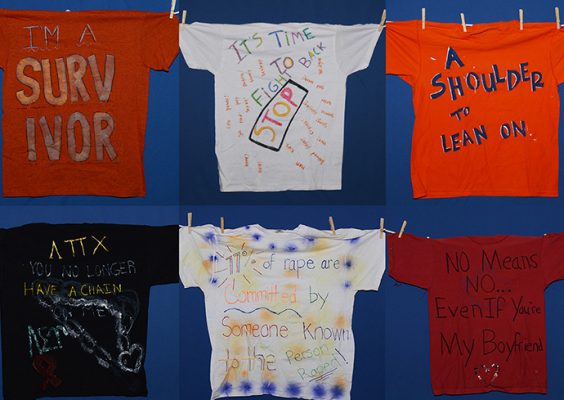 two rows of T-shirts with words about preventing violence written on them