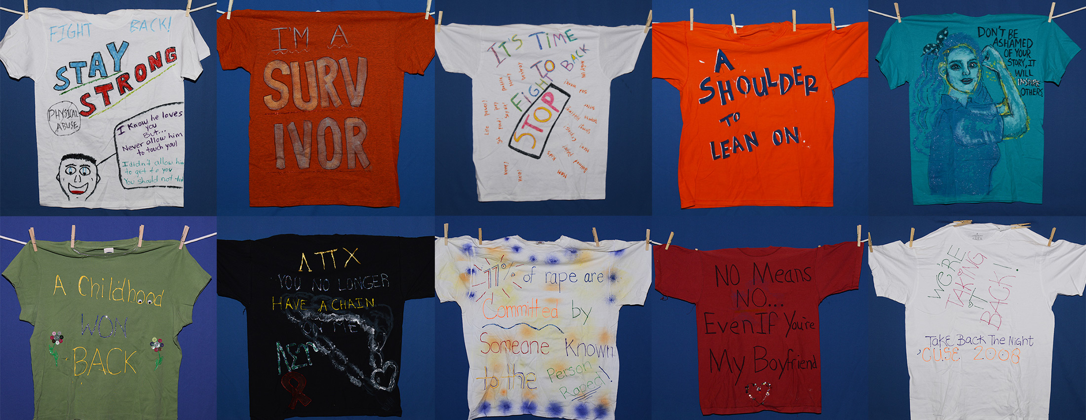 two rows of T-shirts with words about preventing violence and supporting survivors