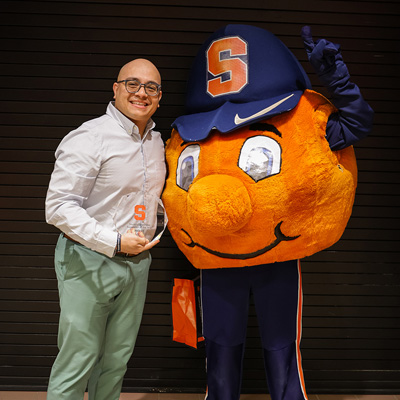 Vicente Cuevas poses with Otto during the Student Employment Week celebration