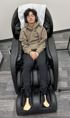a student uses a massage chair at the MindSpa