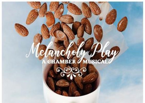 graphic with words Melancholy Play A Chamber musical, showing a mannequin head with almonds floating above it