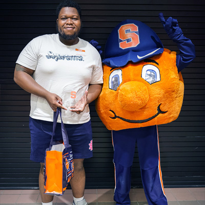 Andre Santibañez poses with Otto during the Student Employment Week celebration