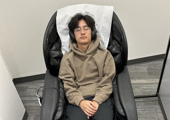 a student uses a massage chair at the MindSpa