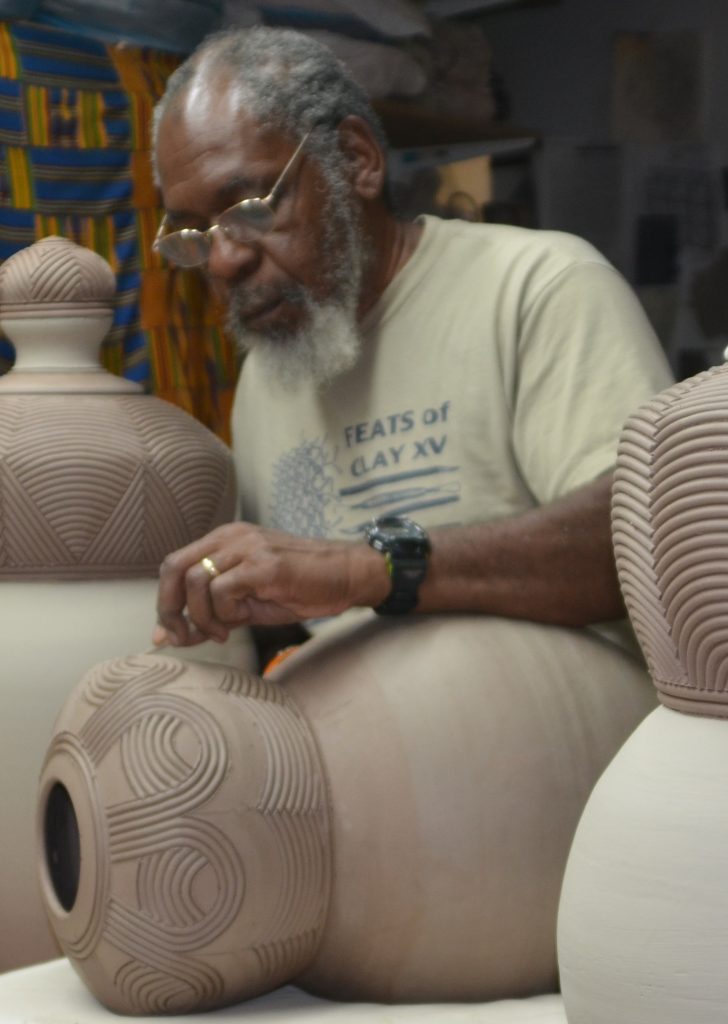 person working on pottery