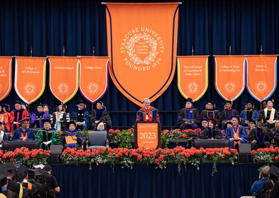 Chancellor Kent Syverud stands at a podium on stage at Commencement.