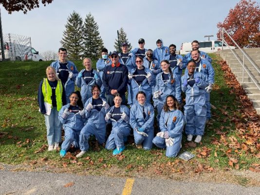 group of Dynamic Sustainability Lab students in protective gear pose together on campus