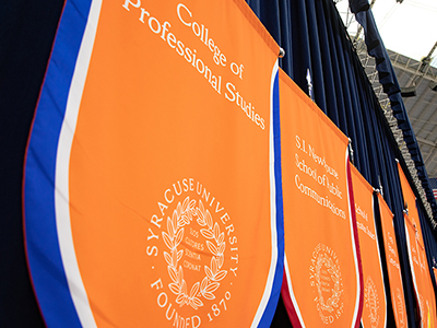 Orange flags with the college names on them