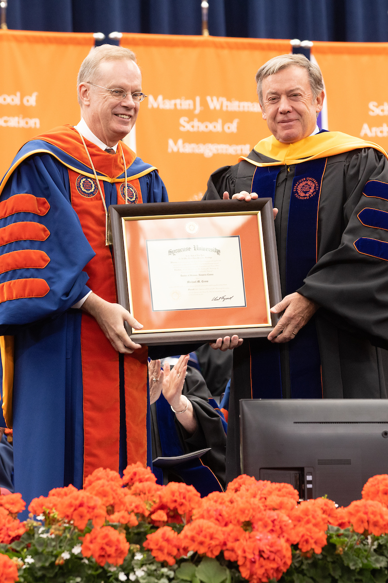 Michael Crow G’85 accepts an honorary degree from Chancellor Syverud at 2023 Commencement