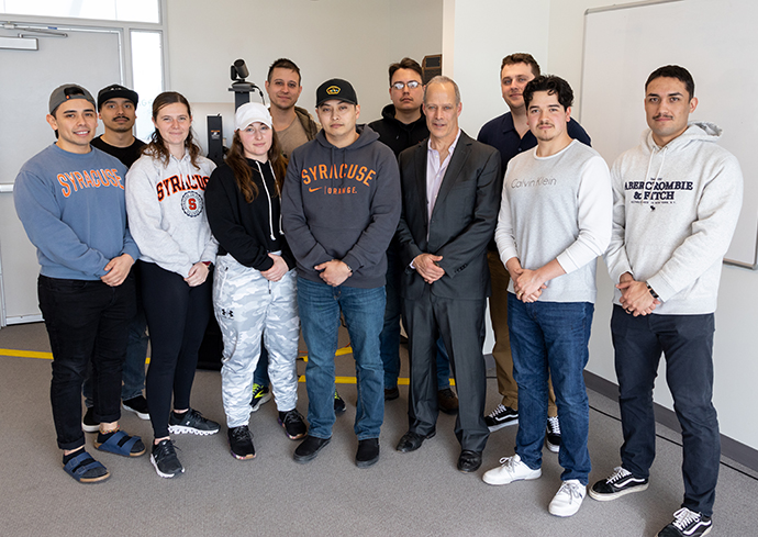 Group of students standing together with event speaker