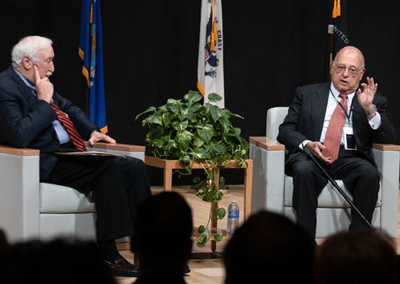 Sean O'Keefe and Bernard Rostker speak together during a veterans summit held on campus
