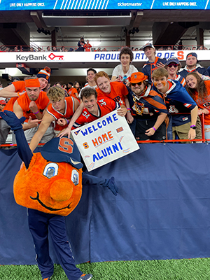 Otto posing with students at a football game