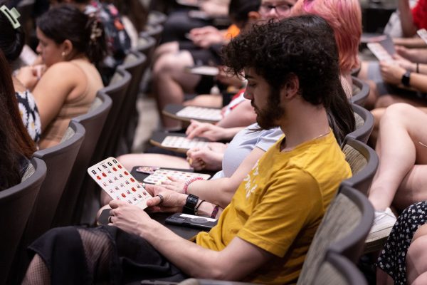 Students sitting in chairs holding BINGO cards.