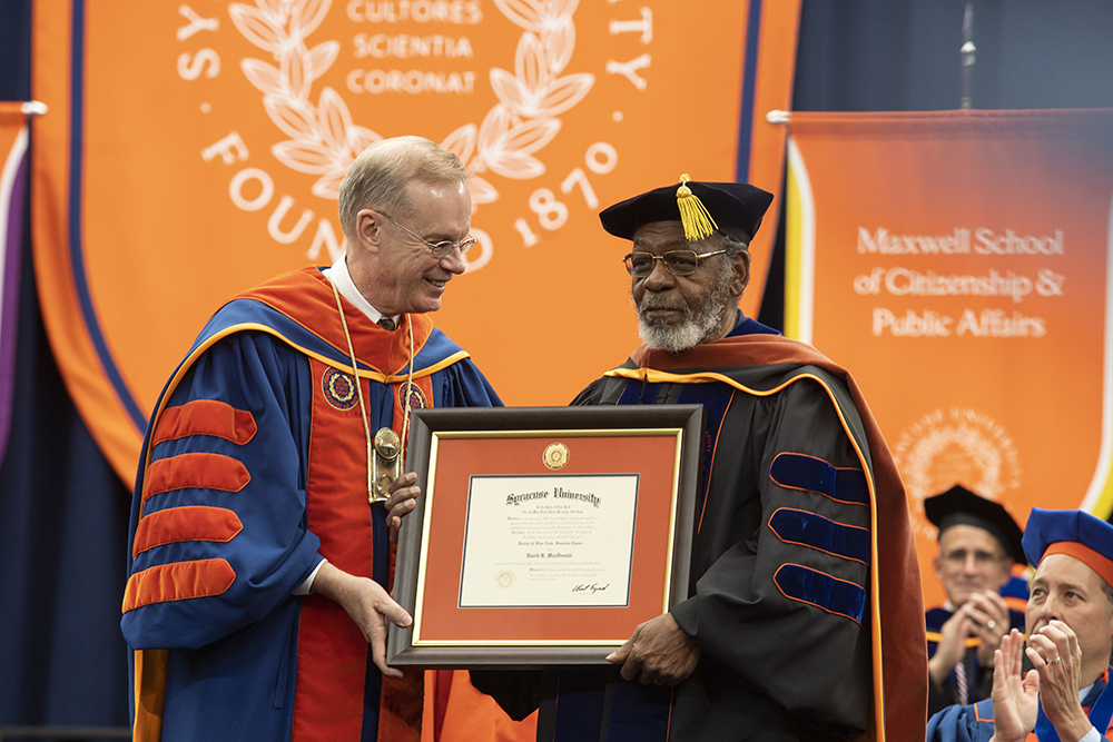 Chancellor Syverud awards an honorary degree to David R. MacDonald at Commencement 2023