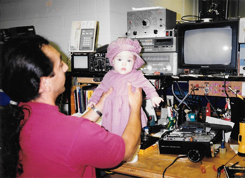 John Mangicaro holds his infant daughter, Gianna, in his Newhouse workspace in 1996.