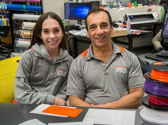 Gianna and John Mangicaro seated together at a table in the ITS MakerSpace