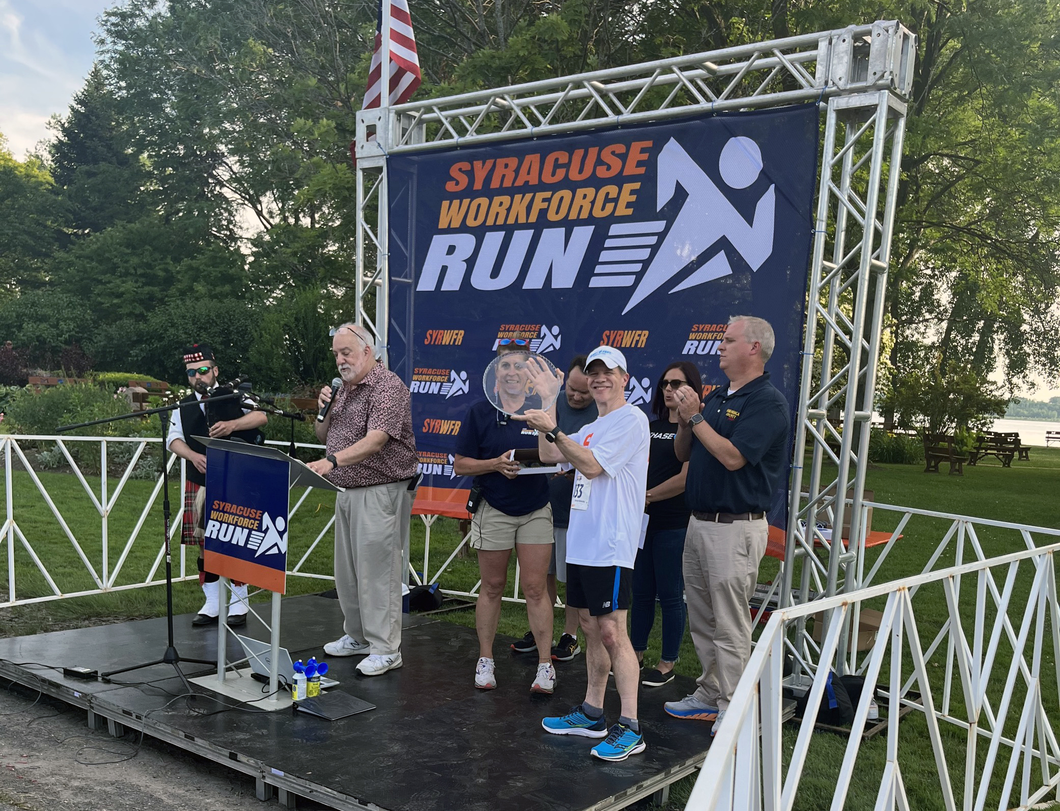 Dean J. Cole Smith accepts award for having the largest team presence at the 2023 Syracuse WorkForce Run