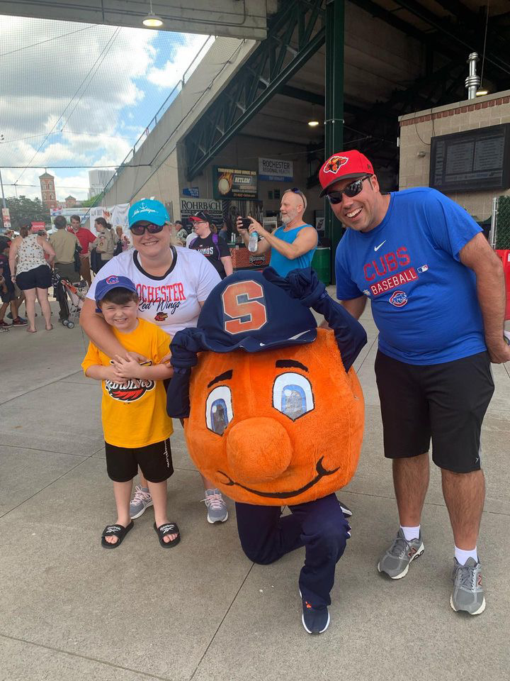 Otto with three individuals at a baseball game.