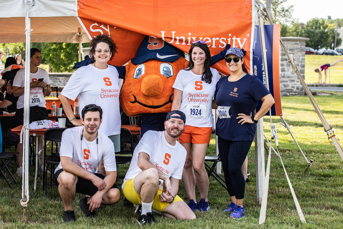 Otto poses with staff members at the 2023 Syracuse WorkForce Run