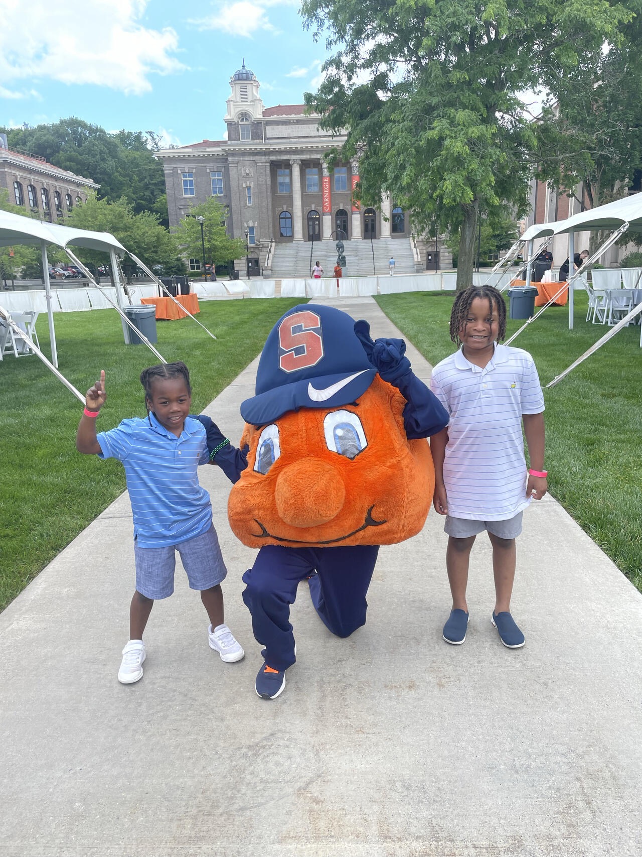 Two little kids standing with Otto on the Quad!