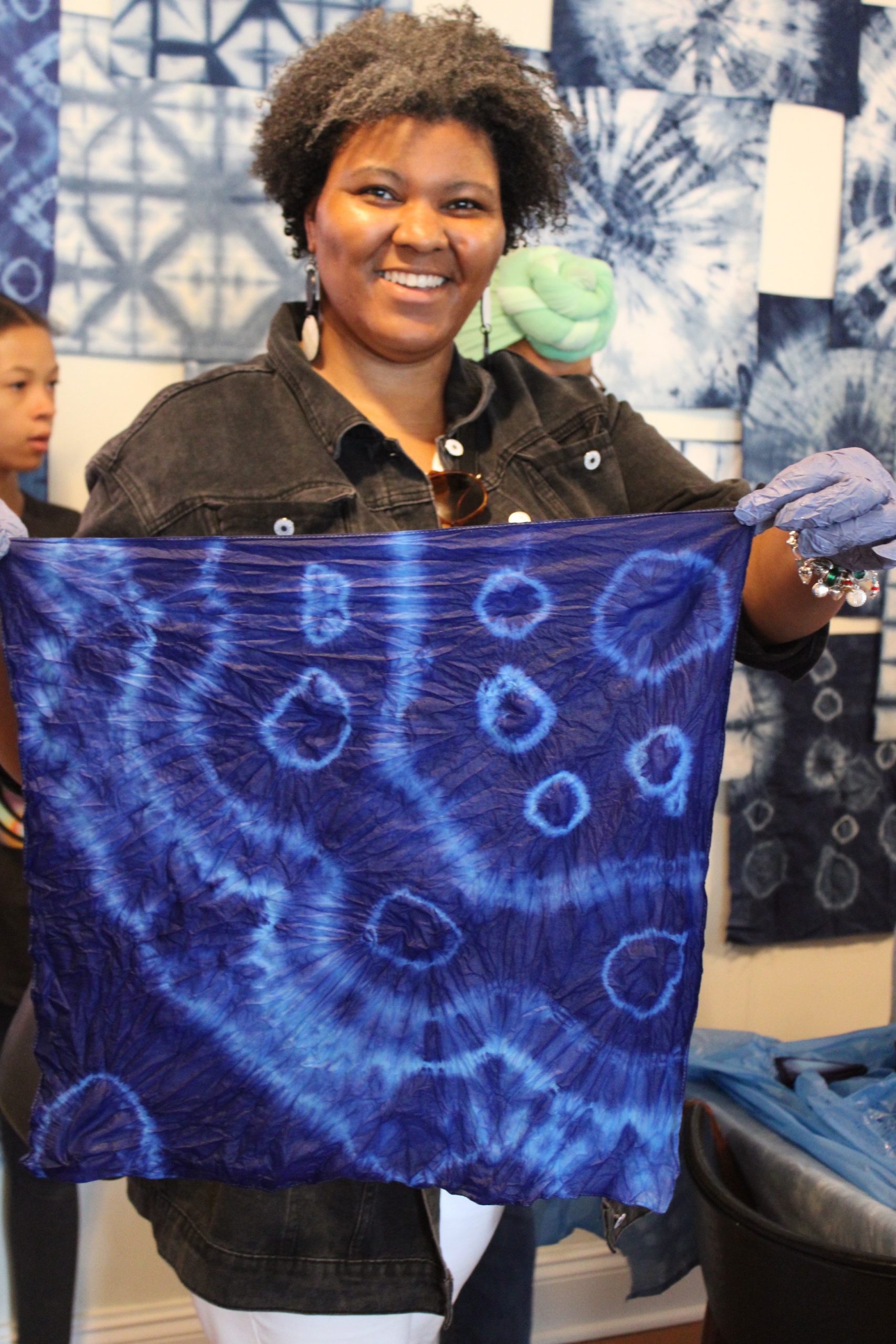 woman holding blue tie-dye fabric cloth
