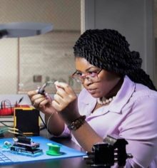 woman doing a experiment holding two items and examining them.