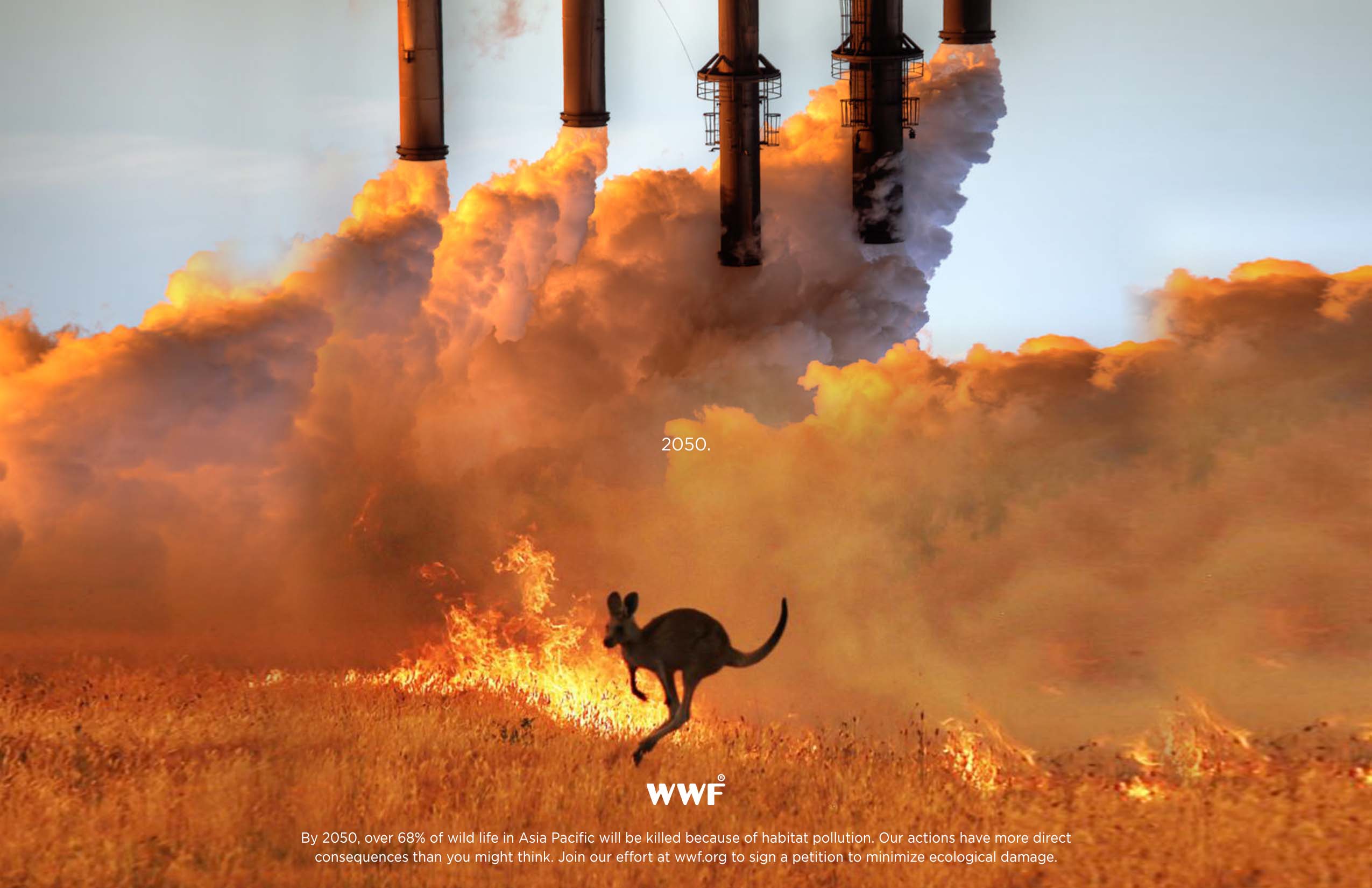 A kangaroo hops in a burning grassland while smoke stacks produce pollution in the background.