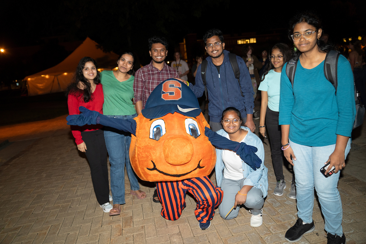 Students pose with Otto at the Y2K party on the Quad during Syracuse Welcome