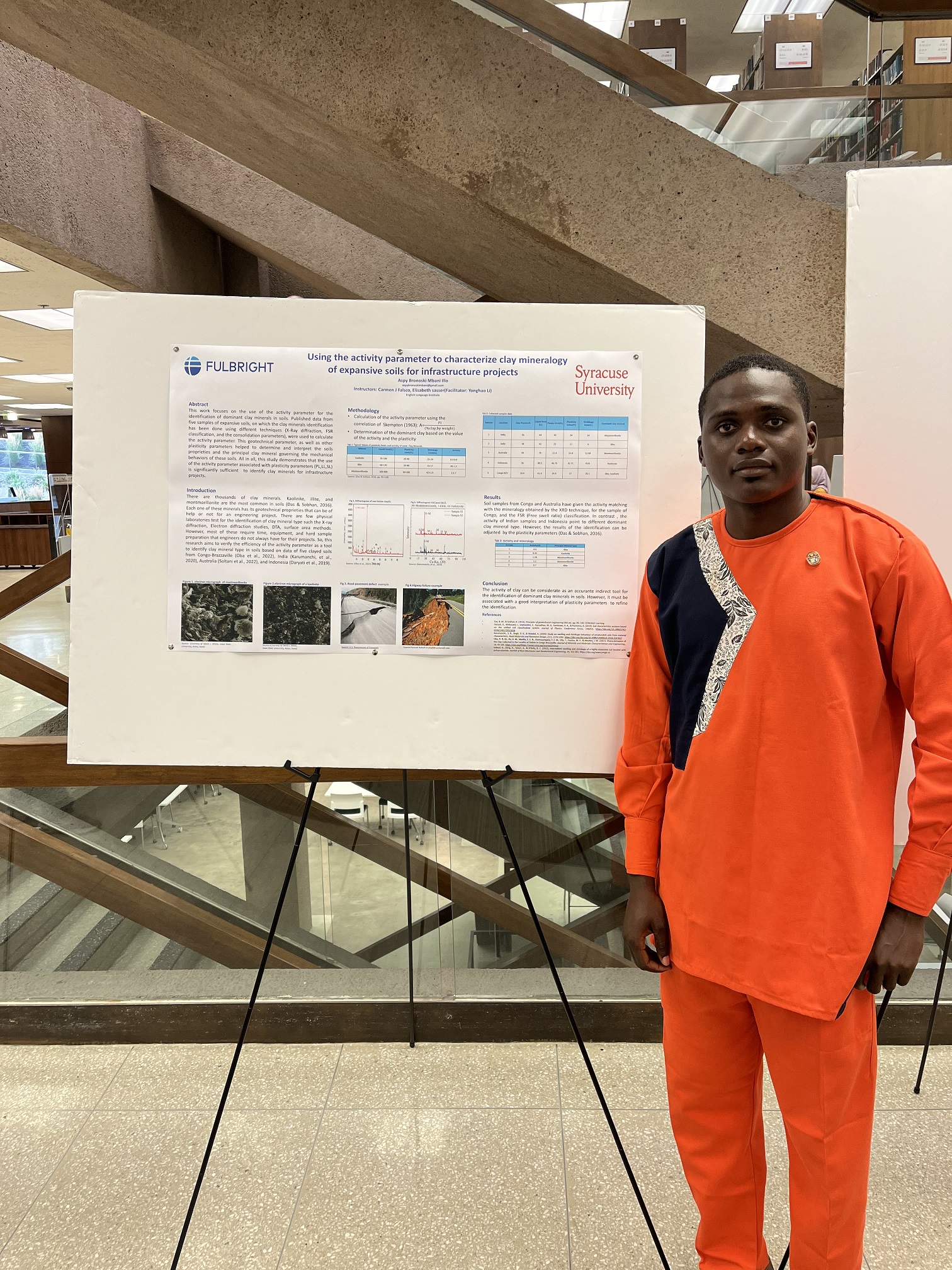 person standing next to a research poster