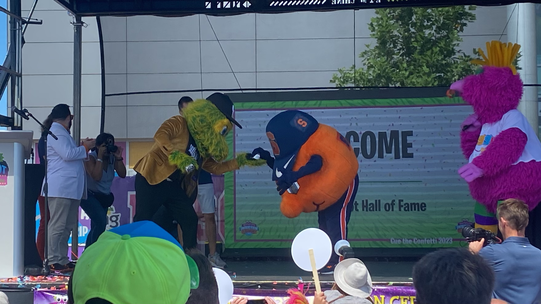 Otto the Orange being awarded their ring by another mascot. 
