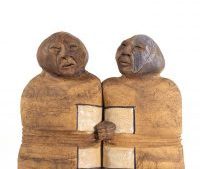 ceramic artwork of two people represented as twins