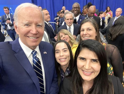 selfie of four individuals with President Joe Biden